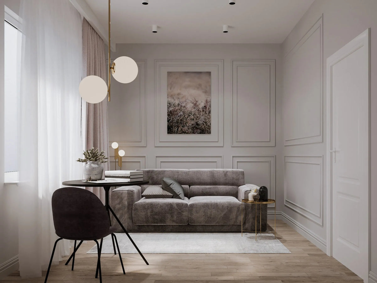 White room with wall panelling and a grey sofa anc table and chair