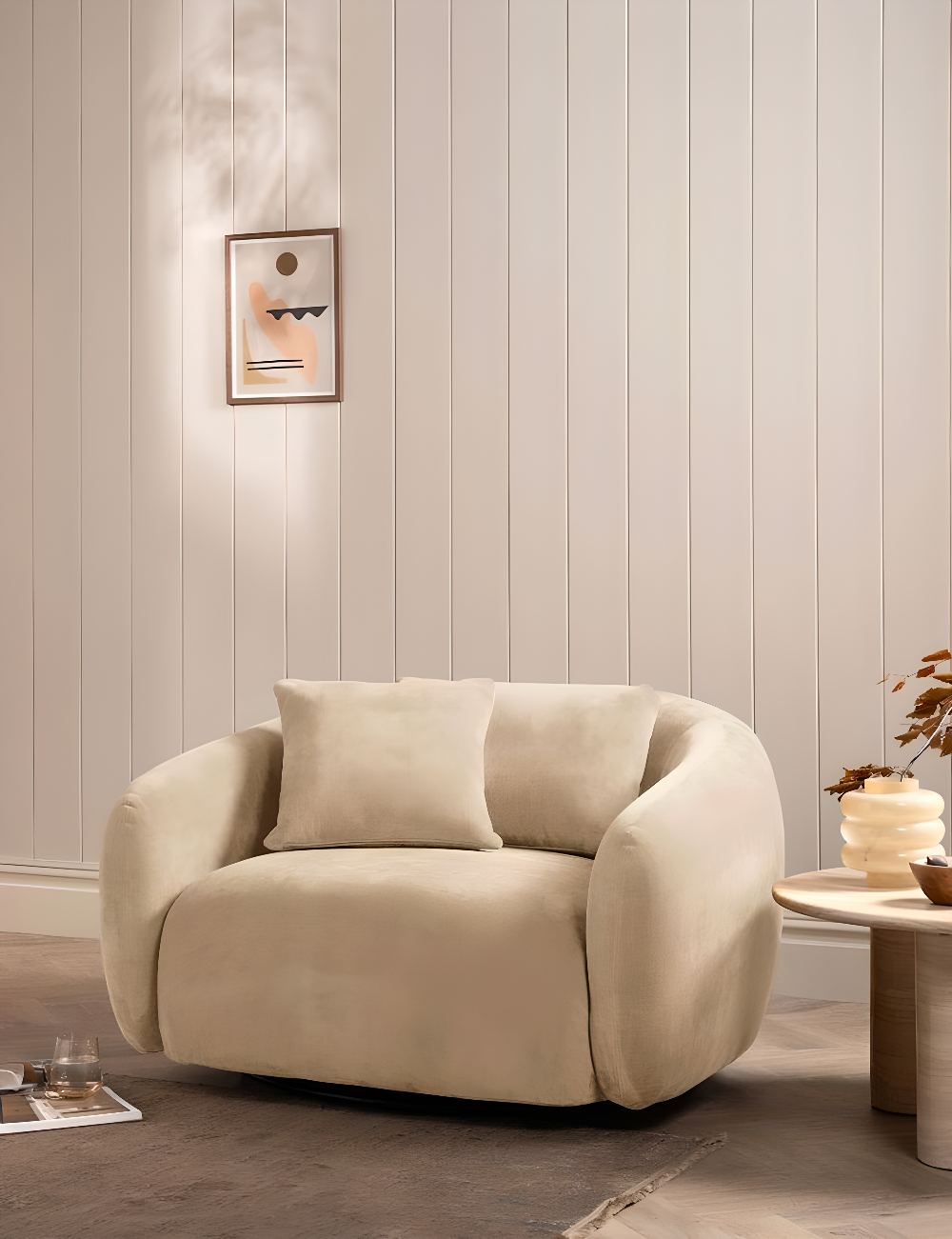 Beige armchair in a room with decorative wall panelling and small table.