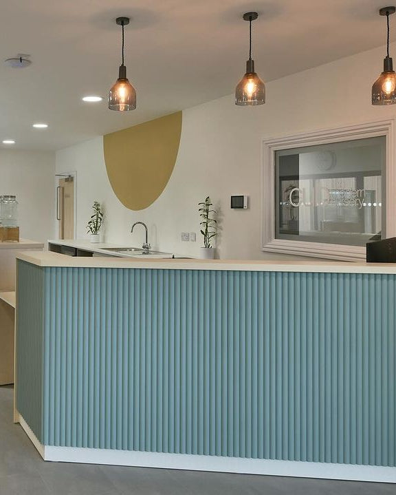 a blue ribbed panelled desk in a commercial space or office.