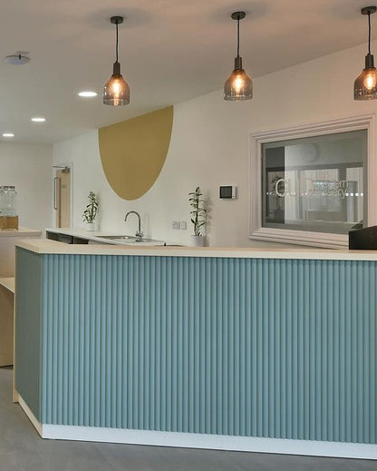 a blue ribbed panelled desk in a commercial space or office.
