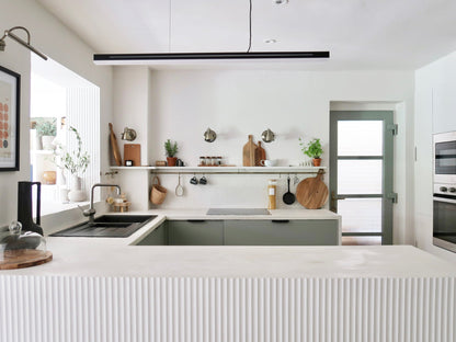 Modern kitchen with white countertops with fluted panelling and gray cabinets