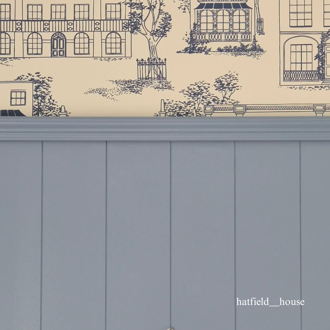 Wallpaper with architectural design and a tongue and groove panelled wall below