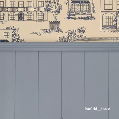 Wallpaper with architectural design and a tongue and groove panelled wall below
