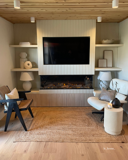 a cosy living space with a wooden ceiling and tv wall featuring white ribbed wall panels.