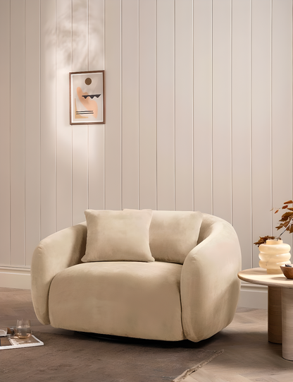 Beige armchair in a room with decorative wall panelling and small table.