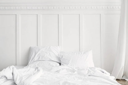 White bedroom with white shaker wall panelling