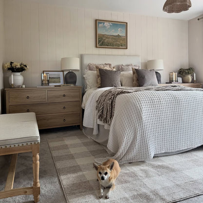 Cozy bedroom with wall panelling a dog standing on the floor