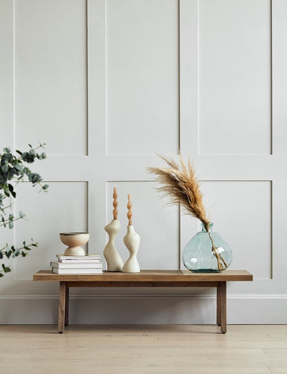 Grey shaker panelled wall with small table featuring decorative items